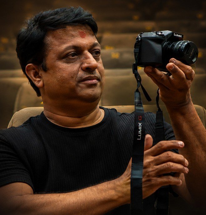 Dilesh Karia holding his camera