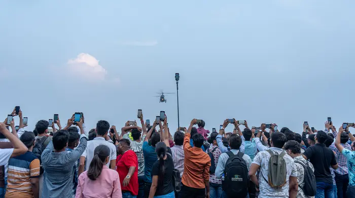 Crowd photographing the sky